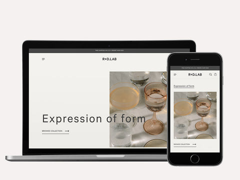 Laptop and iPhone screen showing R+D.LAB Shopify website design by Fashioncan. 